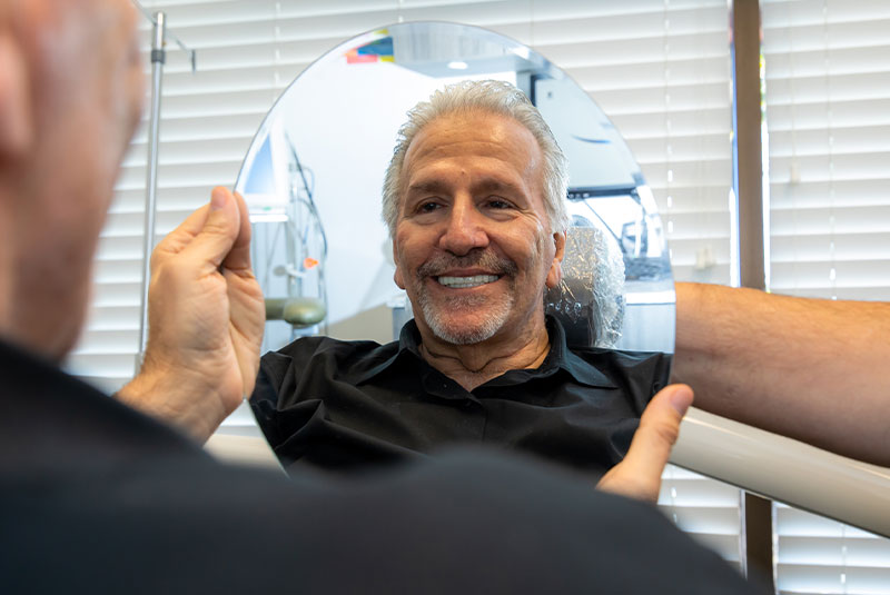 Patient smiling confidently after dental implant procedure